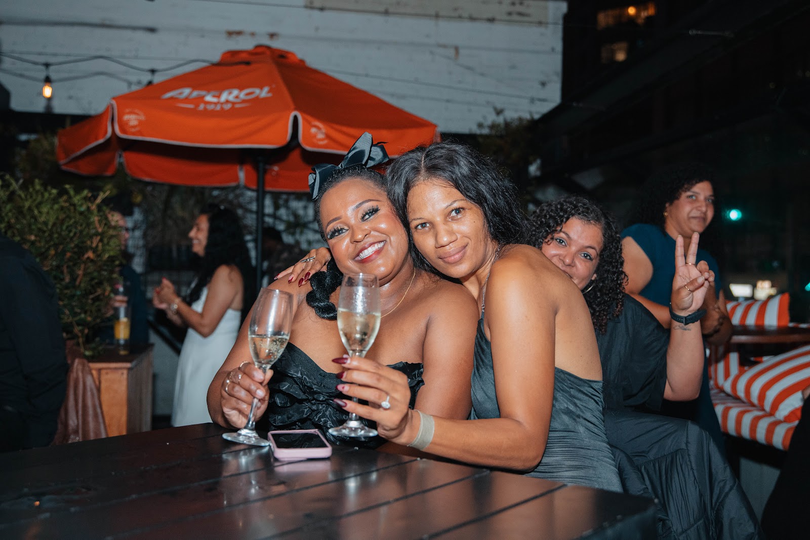 Two friends raising champagne flutes at the table